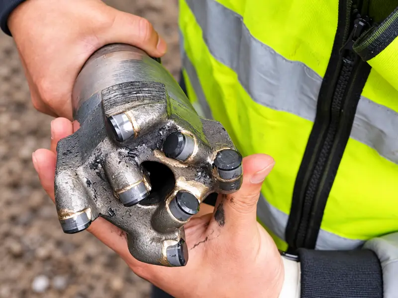 91 mm flat-top PDC drill bit after 100 meters of field drilling, showing cutter and gauge wear
